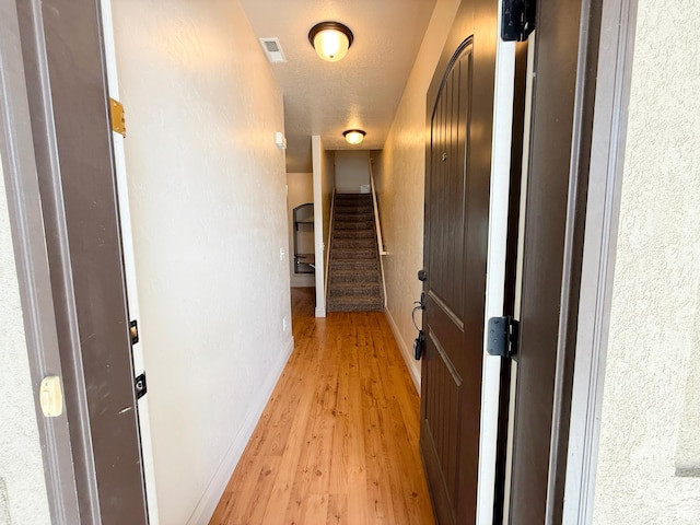141 E 620 S, Smithfield, UT 84335 - corridor featuring light wood-style flooring, a textured ceiling, baseboards, and visible vents