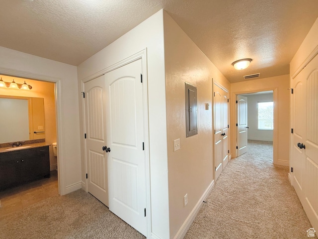 141 E 620 S, Smithfield, UT 84335 - hall featuring baseboards, electric panel, a textured ceiling, visible vents, and light colored carpet