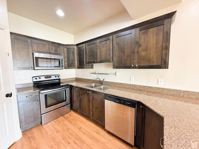 141 E 620 S, Smithfield, UT 84335 - kitchen with dark brown cabinetry, recessed lighting, a sink, stainless steel appliances, and light wood finished floors