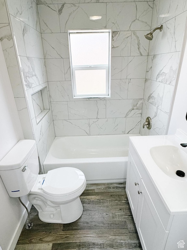 full bath featuring washtub / shower combination, vanity, toilet, and wood finished floors