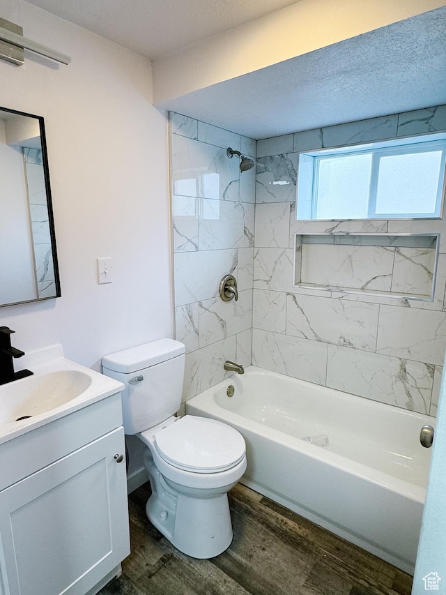full bath featuring toilet, wood finished floors, vanity, and tub / shower combination