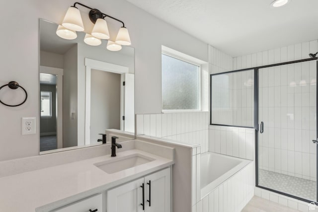 full bath featuring vanity, a stall shower, and a garden tub