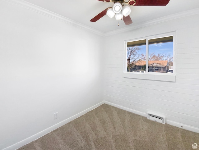 spare room with crown molding, visible vents, ceiling fan, and carpet flooring