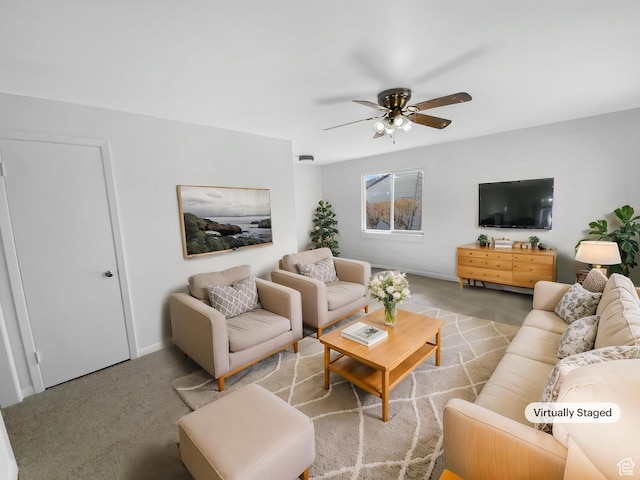 carpeted living area with ceiling fan