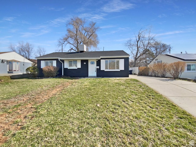 view of front of home with a front yard and fence