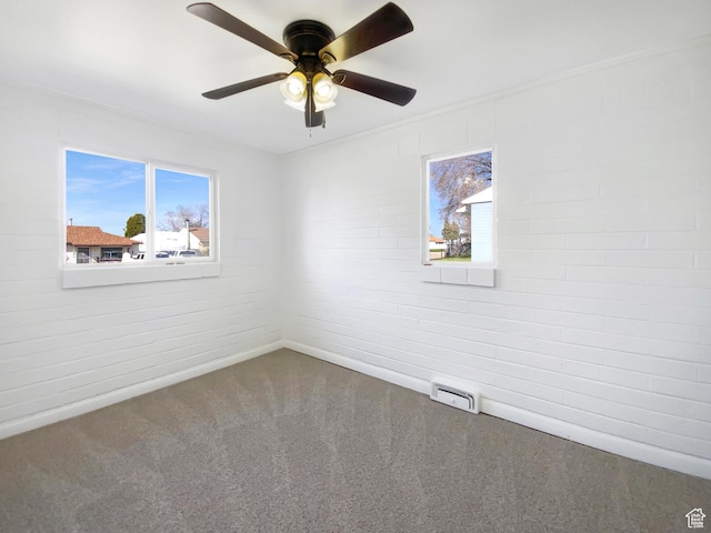 carpeted empty room featuring a ceiling fan