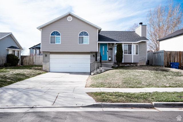 4129 W Misty Dr S, Taylorsville, UT 84129 - tri-level home with brick siding, an attached garage, concrete driveway, and a chimney