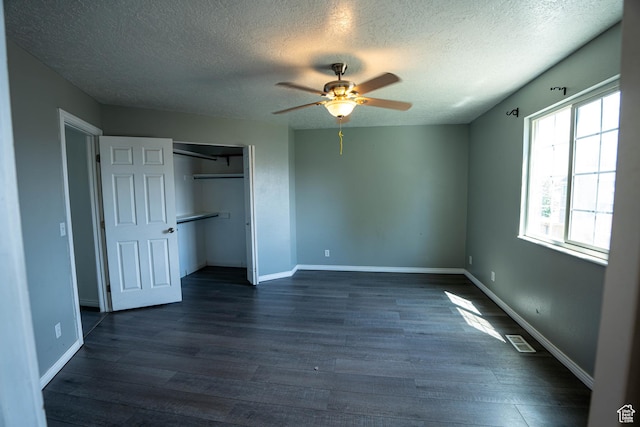 4129 W Misty Dr S, Taylorsville, UT 84129 - unfurnished bedroom with a textured ceiling, dark wood finished floors, a closet, ceiling fan, and baseboards