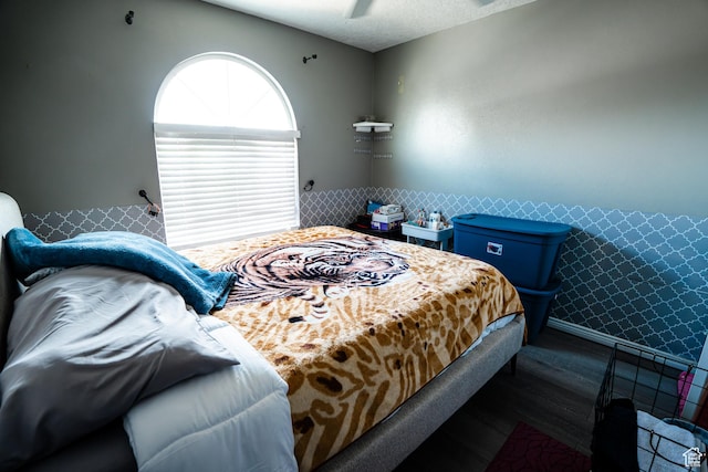 bedroom featuring baseboards, a ceiling fan, and a textured ceiling
