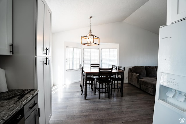 dining area featuring dark wood-style flooring, baseboards, an inviting chandelier, and vaulted ceiling