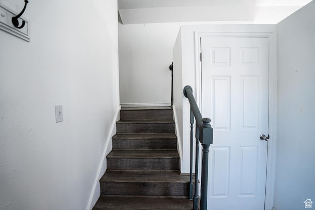 stairs with baseboards and wood finished floors