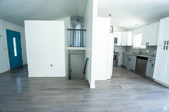 4129 W Misty Dr S, Taylorsville, UT 84129 - kitchen featuring appliances with stainless steel finishes, lofted ceiling, a sink, light wood-style flooring, and light stone countertops