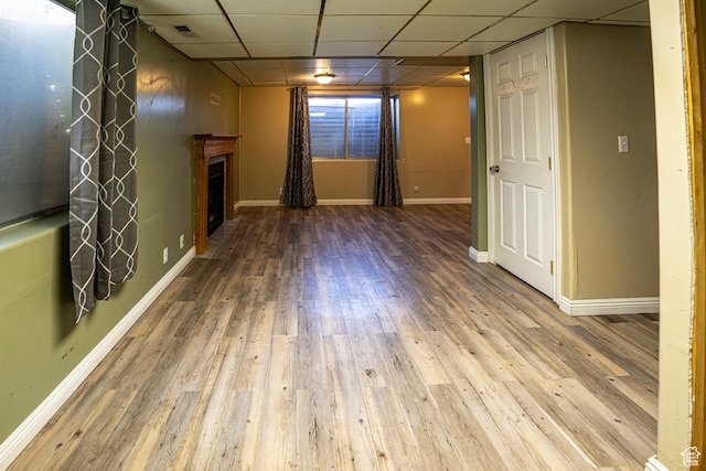 4129 W Misty Dr S, Taylorsville, UT 84129 - unfurnished living room with a paneled ceiling, wood finished floors, a fireplace, and baseboards
