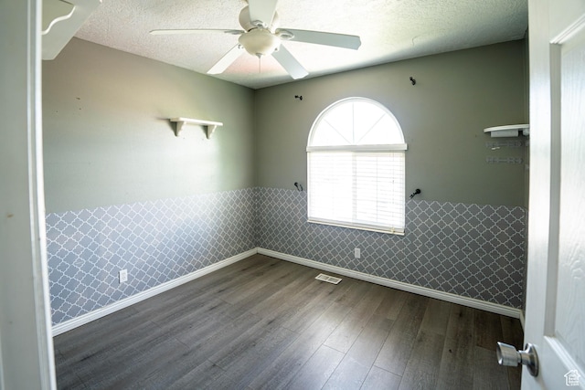 4129 W Misty Dr S, Taylorsville, UT 84129 - empty room with wainscoting, a ceiling fan, dark wood-style floors, baseboards, and a textured ceiling