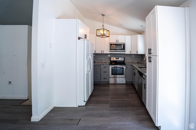 4129 W Misty Dr S, Taylorsville, UT 84129 - kitchen featuring appliances with stainless steel finishes, lofted ceiling, dark wood finished floors, backsplash, and a chandelier