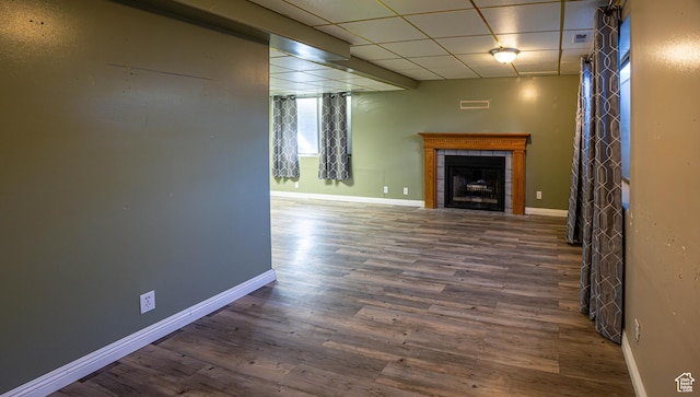4129 W Misty Dr S, Taylorsville, UT 84129 - unfurnished living room featuring a tile fireplace, baseboards, wood finished floors, and a paneled ceiling