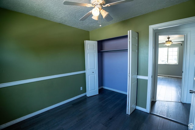 4129 W Misty Dr S, Taylorsville, UT 84129 - unfurnished bedroom featuring dark wood finished floors, a textured ceiling, baseboards, a closet, and a ceiling fan