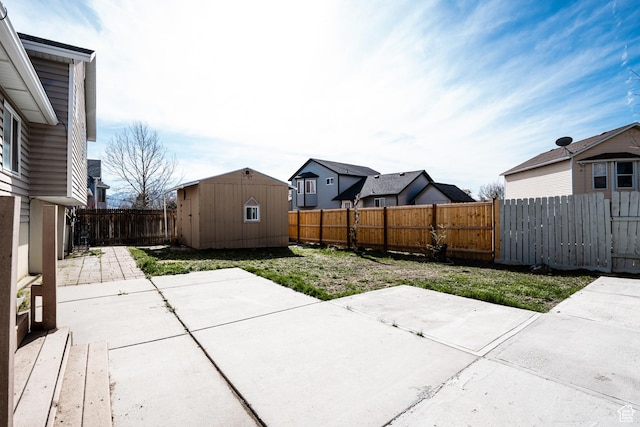view of patio / terrace featuring an outbuilding, a fenced backyard, and a storage shed