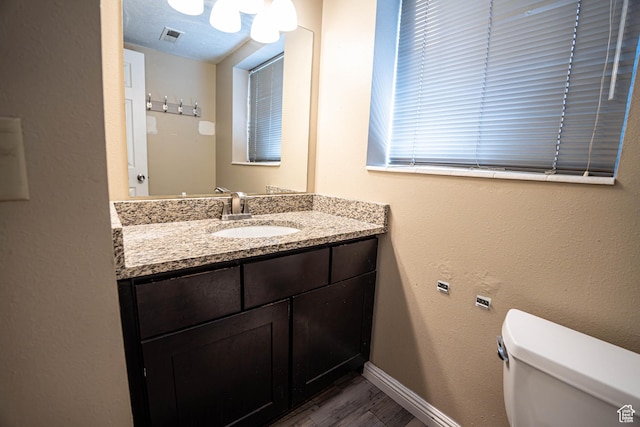 4129 W Misty Dr S, Taylorsville, UT 84129 - bathroom featuring toilet, vanity, wood finished floors, and baseboards