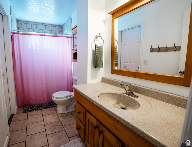 bathroom with a shower with curtain, toilet, a textured ceiling, vanity, and tile patterned floors