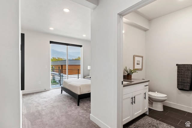 bathroom with toilet, vanity, baseboards, and recessed lighting