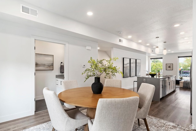 dining room with recessed lighting, visible vents, and wood finished floors