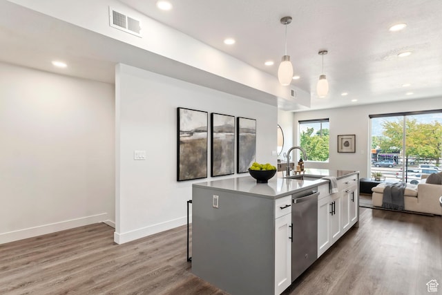kitchen with visible vents, dishwasher, a sink, open floor plan, and white cabinetry