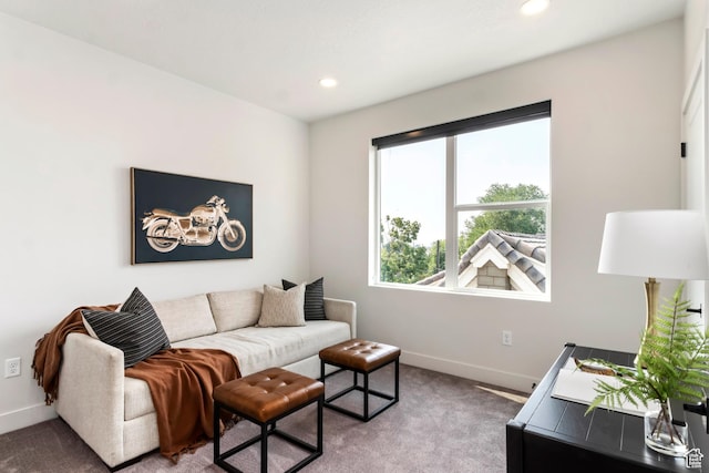 living area featuring recessed lighting, baseboards, and light colored carpet
