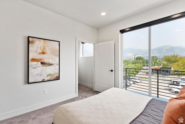 bedroom featuring access to outside, baseboards, a mountain view, light carpet, and recessed lighting