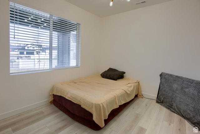 2543 W 3350 S Unit 210, Syracuse, UT 84075 - bedroom featuring wood finished floors, visible vents, and baseboards