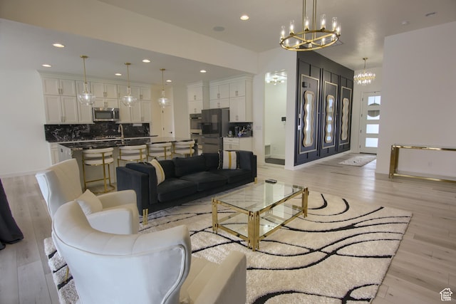 2543 W 3350 S Unit 210, Syracuse, UT 84075 - living area with recessed lighting, light wood-style flooring, baseboards, and an inviting chandelier