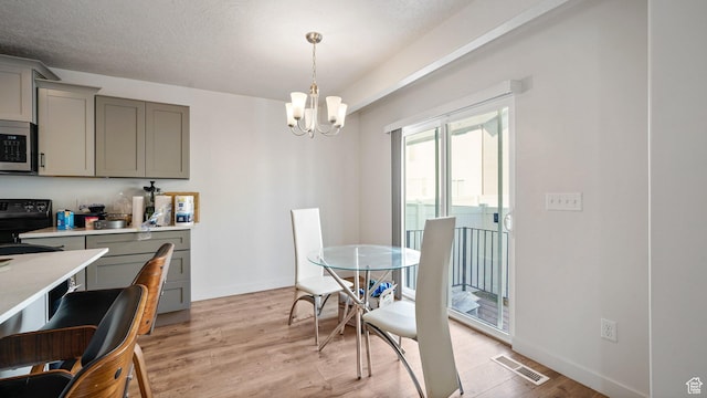 448 S Pegasus Way, Saratoga Springs, UT 84045 - dining space with a textured ceiling, visible vents, light wood finished floors, a notable chandelier, and baseboards