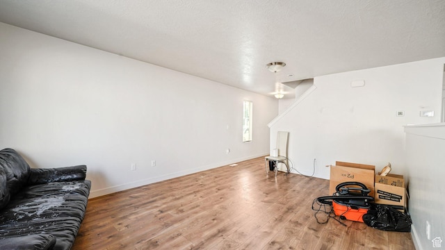 448 S Pegasus Way, Saratoga Springs, UT 84045 - living room featuring baseboards, light wood-type flooring, and a textured ceiling