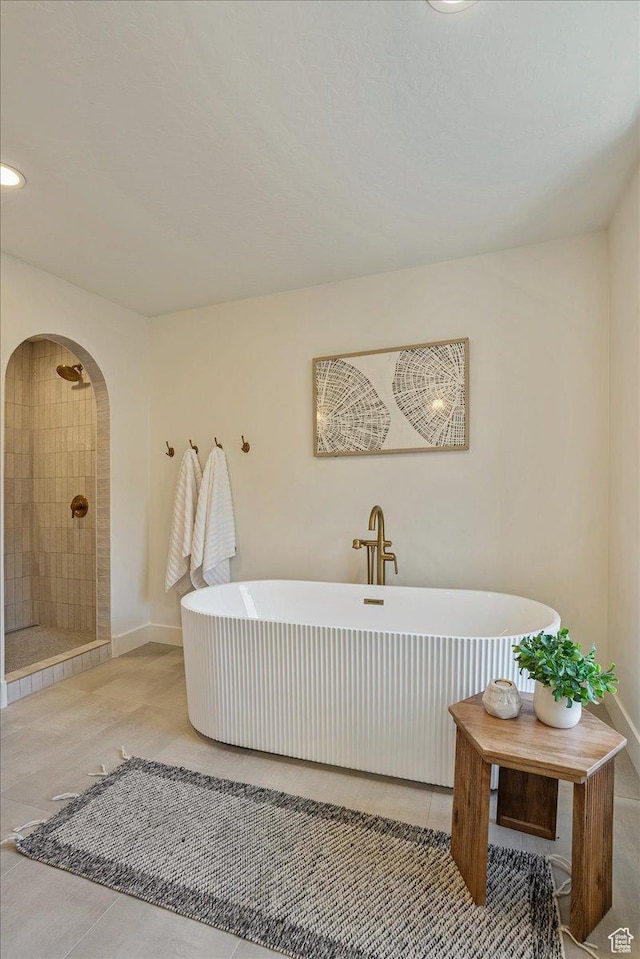 5290 E Emigration Canyon Rd, Salt Lake City, UT 84108 - full bath featuring tiled shower, baseboards, tile patterned flooring, and a soaking tub
