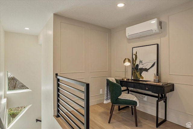 5290 E Emigration Canyon Rd, Salt Lake City, UT 84108 - office space featuring a textured ceiling, a decorative wall, wood finished floors, and an AC wall unit