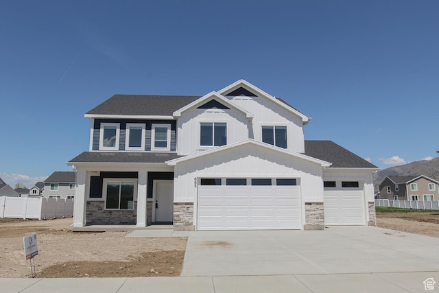 685 E 1250 S, Hyrum, UT 84319 - craftsman-style home featuring concrete driveway, stone siding, board and batten siding, and fence
