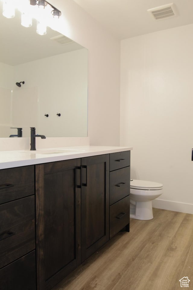685 E 1250 S, Hyrum, UT 84319 - full bathroom with toilet, wood finished floors, visible vents, baseboards, and vanity