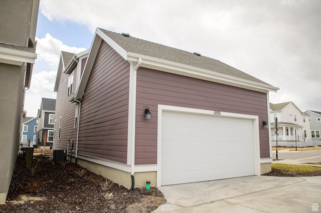 11531 S Bingham Rim Rd, South Jordan, UT 84009 - view of property exterior featuring a garage, driveway, and central AC