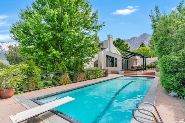 276 S 600 E, Alpine, UT 84004 - view of swimming pool featuring a deck with mountain view, a diving board, and a fenced in pool