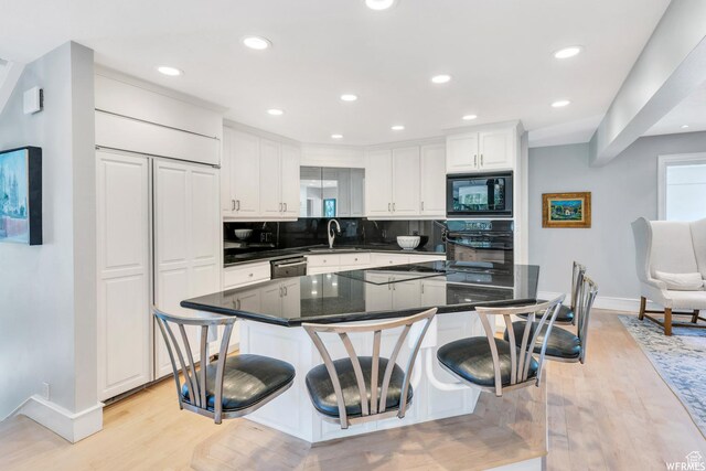 276 S 600 E, Alpine, UT 84004 - kitchen featuring a kitchen breakfast bar, light wood-style flooring, white cabinetry, backsplash, and black appliances
