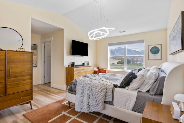 473 S 2400 W Unit 3, Springville, UT 84663 - bedroom featuring a notable chandelier, baseboards, light wood-style floors, visible vents, and lofted ceiling