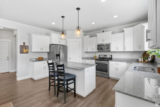 516 W 1000 N, Mapleton, UT 84664 - kitchen with a center island, white cabinetry, stainless steel appliances, a sink, and wood finished floors