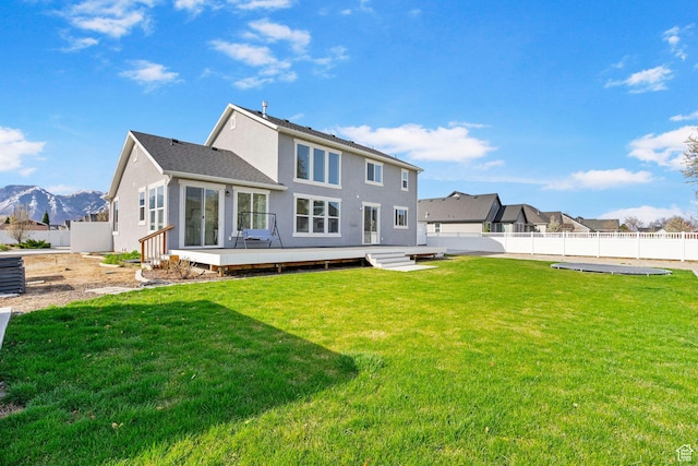 516 W 1000 N, Mapleton, UT 84664 - back of property with a fenced backyard, a deck with mountain view, a lawn, and stucco siding