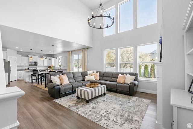 516 W 1000 N, Mapleton, UT 84664 - living area with wood finished floors, a notable chandelier, and a wealth of natural light