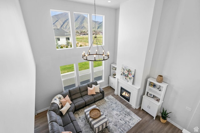 516 W 1000 N, Mapleton, UT 84664 - living area featuring dark wood-style flooring, an inviting chandelier, baseboards, and a wealth of natural light