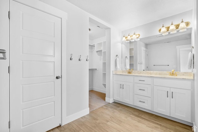 516 W 1000 N, Mapleton, UT 84664 - full bath with double vanity, baseboards, a sink, and wood finished floors