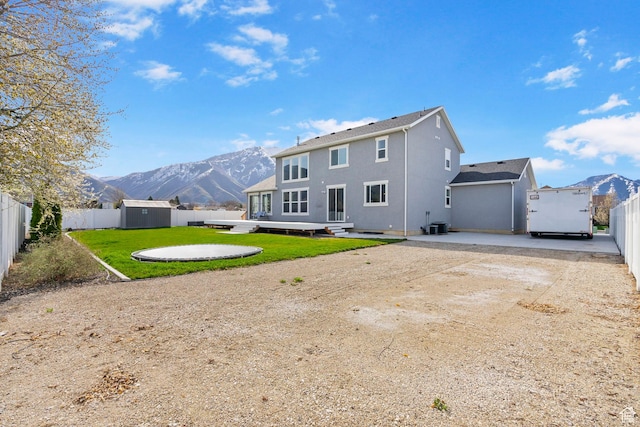 516 W 1000 N, Mapleton, UT 84664 - back of property with a mountain view, a fenced backyard, an outdoor structure, and driveway