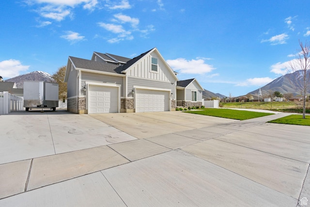 516 W 1000 N, Mapleton, UT 84664 - view of side of property with a mountain view, driveway, stone siding, board and batten siding, and a yard