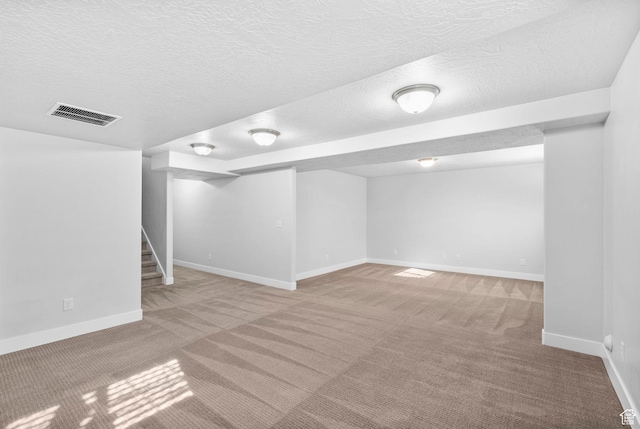 516 W 1000 N, Mapleton, UT 84664 - finished below grade area with baseboards, a textured ceiling, stairs, visible vents, and carpet