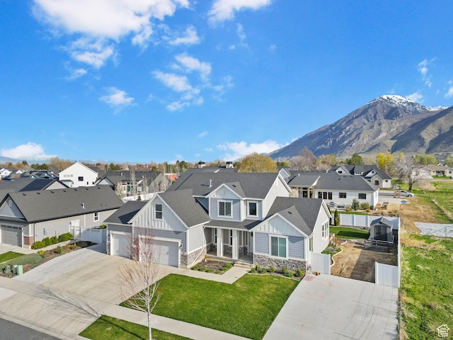 516 W 1000 N, Mapleton, UT 84664 - view of front of house featuring board and batten siding, stone siding, a front lawn, concrete driveway, and a residential view